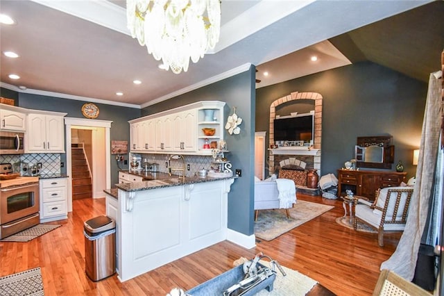 4742 Thunder River Dr, Gainesville, GA 30506 - kitchen with stainless steel appliances, open shelves, white cabinetry, crown molding, and dark stone counters