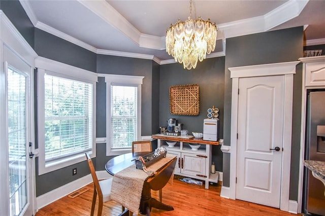 4742 Thunder River Dr, Gainesville, GA 30506 - dining area with a chandelier, plenty of natural light, light wood-type flooring, and ornamental molding