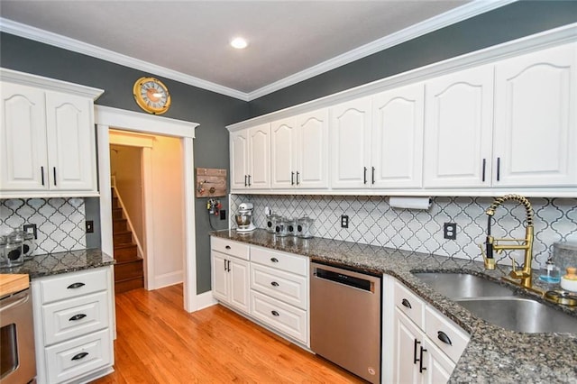 4742 Thunder River Dr, Gainesville, GA 30506 - kitchen featuring stainless steel dishwasher, white cabinetry, light wood-style floors, decorative backsplash, and dark stone counters