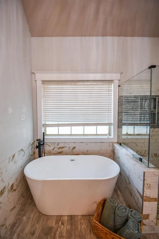 4742 Thunder River Dr, Gainesville, GA 30506 - full bathroom featuring tile walls, a freestanding bath, plenty of natural light, wainscoting, and a shower