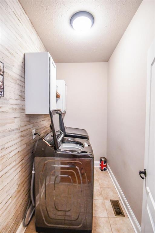 4742 Thunder River Dr, Gainesville, GA 30506 - laundry room with washer and clothes dryer, cabinet space, a textured ceiling, light tile patterned flooring, and an office area