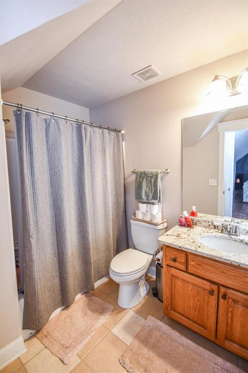 4742 Thunder River Dr, Gainesville, GA 30506 - bathroom featuring tile patterned flooring, vanity, and shower / bath combination with curtain