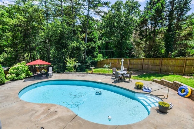 4742 Thunder River Dr, Gainesville, GA 30506 - view of swimming pool with a patio area, outdoor dining space, a fenced backyard, and view of wooded area