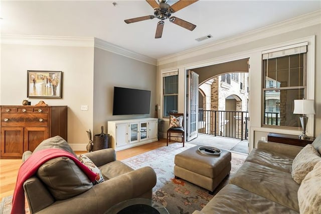 living room with ceiling fan, light wood-type flooring, and crown molding