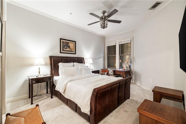 bedroom with light carpet, ceiling fan, and crown molding