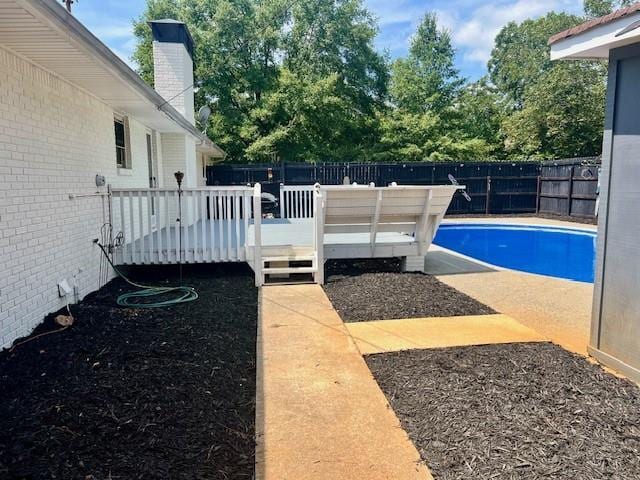 view of pool featuring a fenced backyard, a fenced in pool, and a wooden deck