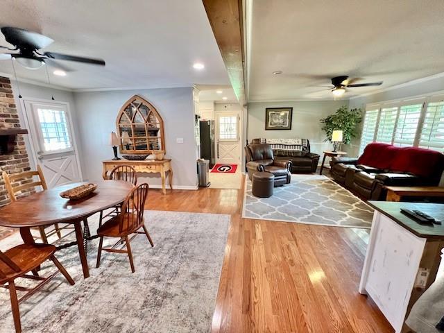 dining space featuring plenty of natural light, ceiling fan, and wood finished floors