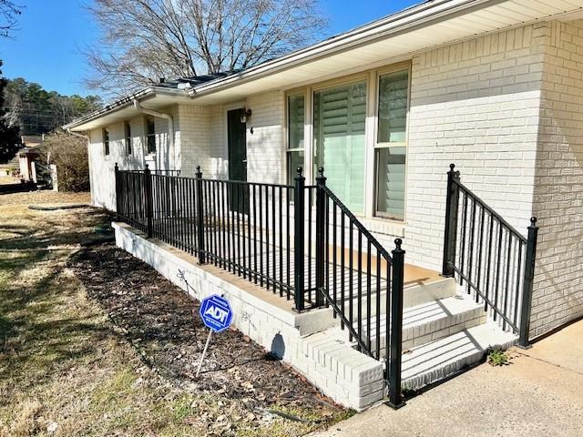 view of exterior entry with brick siding