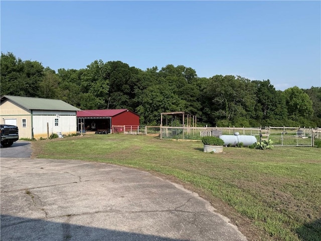 222 Akin Rd, Martin, GA 30557 - view of yard featuring a pole building, driveway, an outdoor structure, a view of trees, and a detached garage