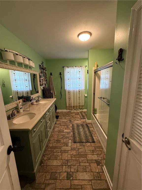 222 Akin Rd, Martin, GA 30557 - bathroom featuring an enclosed shower, double vanity, baseboards, and brick floors