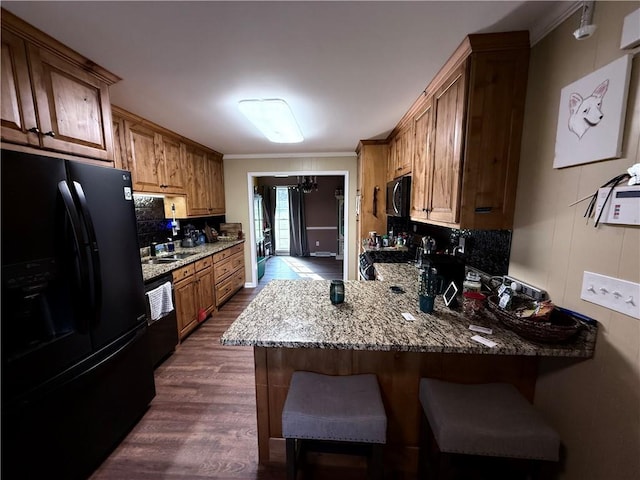 222 Akin Rd, Martin, GA 30557 - kitchen with black appliances, tasteful backsplash, dark wood-style floors, a peninsula, and a kitchen bar