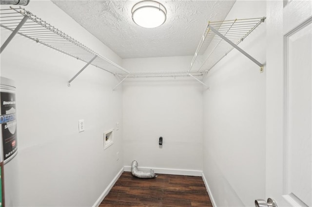 clothes washing area featuring laundry area, baseboards, wood finished floors, hookup for a washing machine, and a textured ceiling