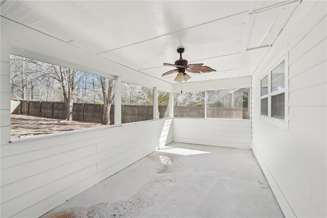 unfurnished sunroom featuring ceiling fan