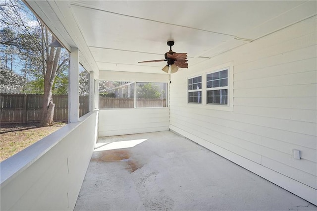 view of patio with ceiling fan and fence