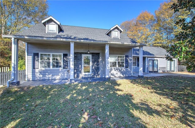 cape cod home featuring a front yard