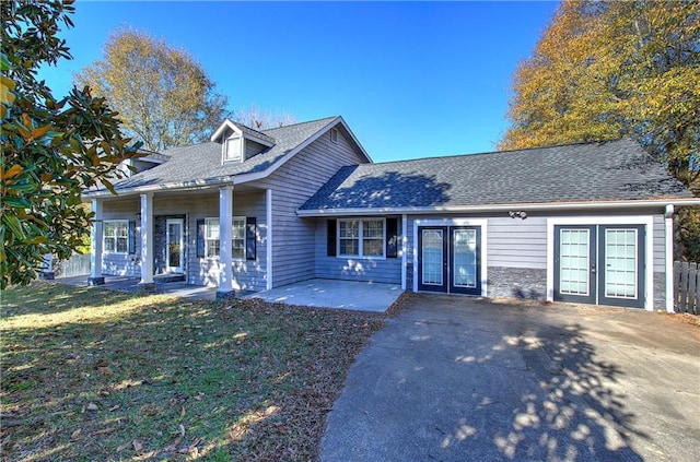 view of front of home with a front lawn, a patio area, and french doors