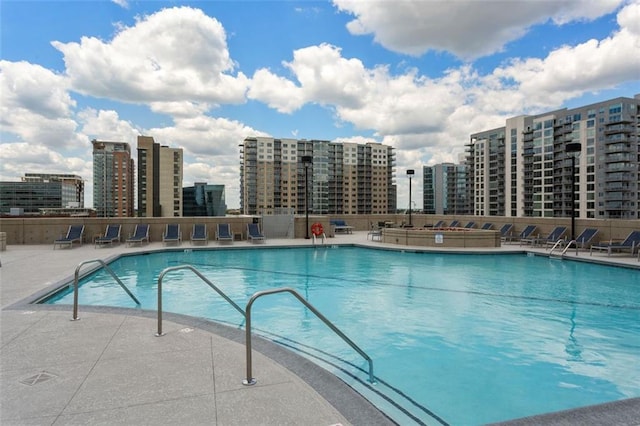 community pool featuring a view of city and a patio