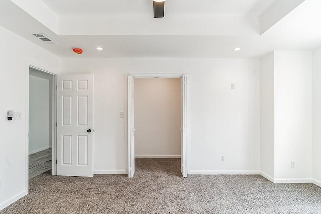 unfurnished bedroom with recessed lighting, baseboards, visible vents, and carpet