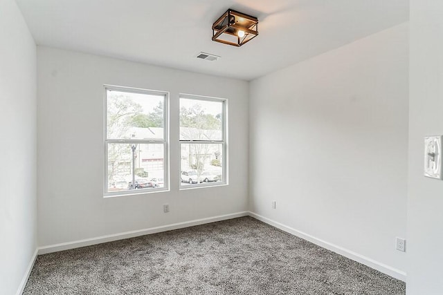 carpeted empty room with baseboards and visible vents