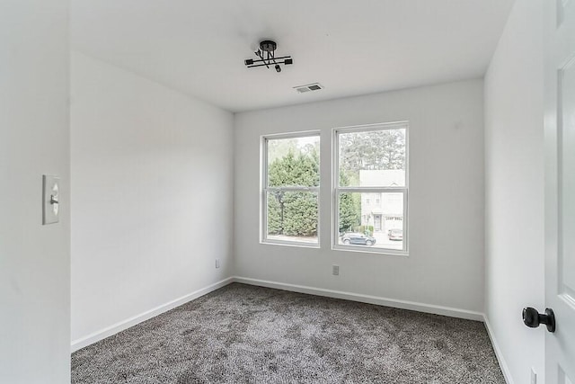 empty room with baseboards, carpet flooring, and visible vents