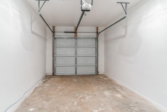 garage with baseboards and a garage door opener
