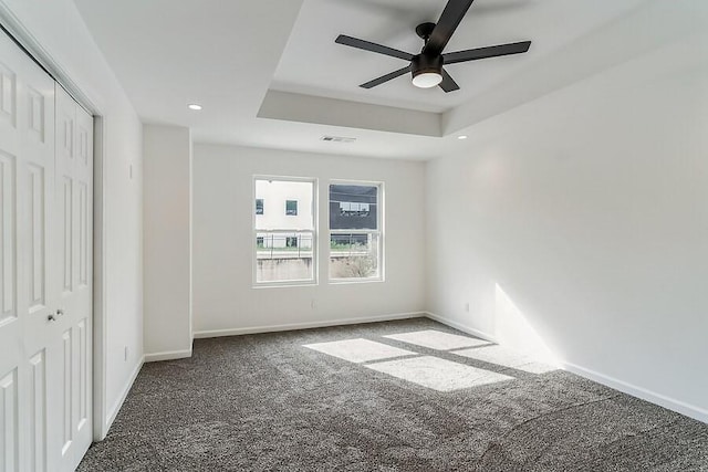 unfurnished bedroom featuring visible vents, carpet flooring, baseboards, and a closet