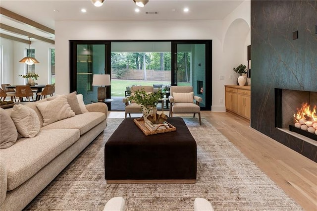 living room with a fireplace and light hardwood / wood-style floors