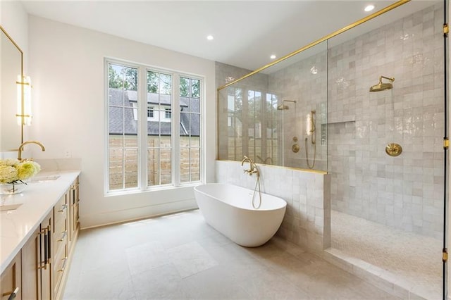 bathroom featuring shower with separate bathtub and vanity