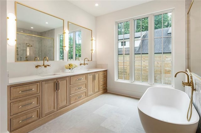 bathroom with vanity, a wealth of natural light, and plus walk in shower