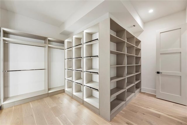 spacious closet with hardwood / wood-style floors