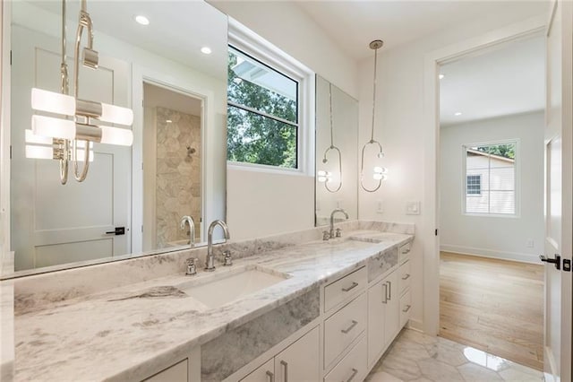 bathroom with a wealth of natural light, hardwood / wood-style floors, and vanity