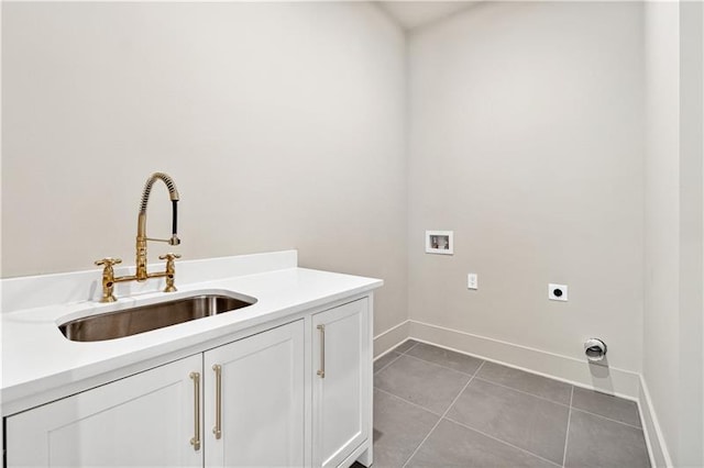 washroom with hookup for an electric dryer, hookup for a washing machine, cabinets, sink, and light tile patterned flooring