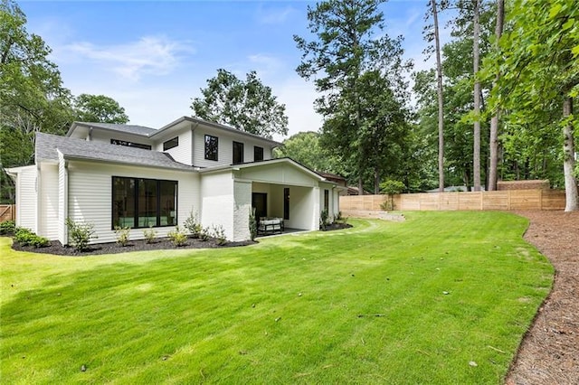 rear view of house with a lawn