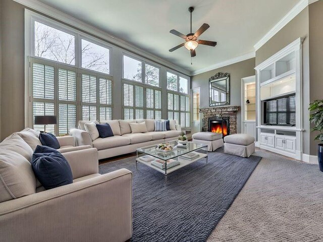 535 Crested Hawk Rdg, Canton, GA 30114 - carpeted living room with ceiling fan, crown molding, and a stone fireplace