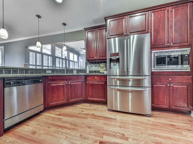 535 Crested Hawk Rdg, Canton, GA 30114 - kitchen featuring pendant lighting, appliances with stainless steel finishes, crown molding, and a sink