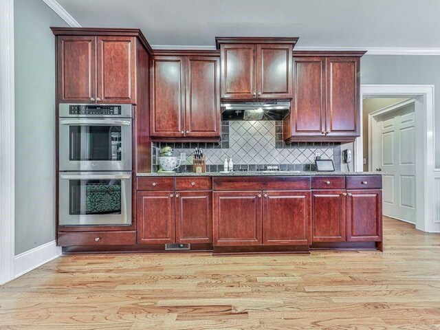 535 Crested Hawk Rdg, Canton, GA 30114 - kitchen with light wood finished floors, stainless steel double oven, extractor fan, and crown molding