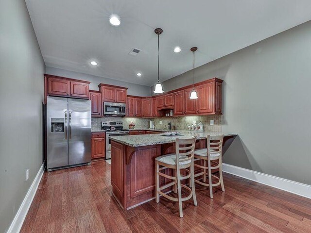 535 Crested Hawk Rdg, Canton, GA 30114 - kitchen featuring dark wood finished floors, visible vents, appliances with stainless steel finishes, and decorative backsplash