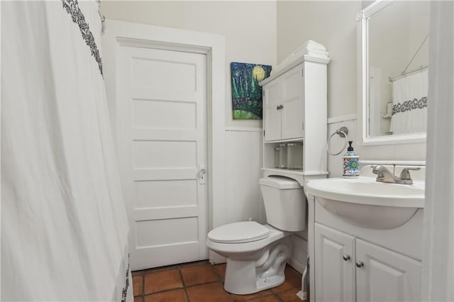 1096 Tilden St NW, Atlanta, GA 30318 - bathroom with toilet, tile patterned flooring, vanity, and wainscoting