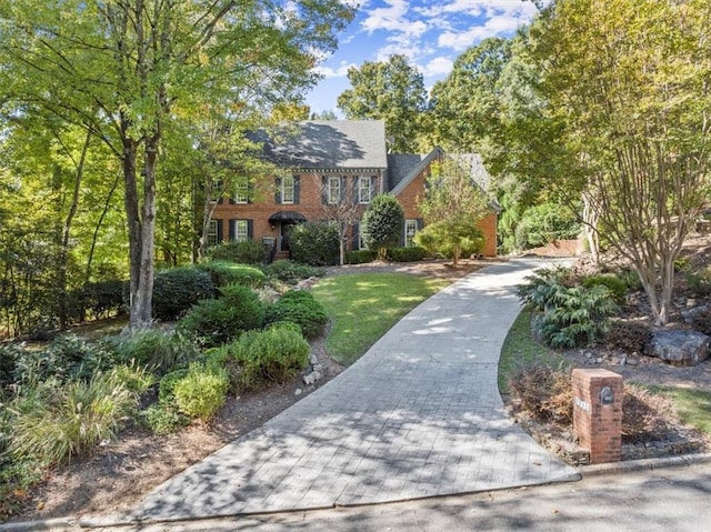 colonial house featuring brick siding