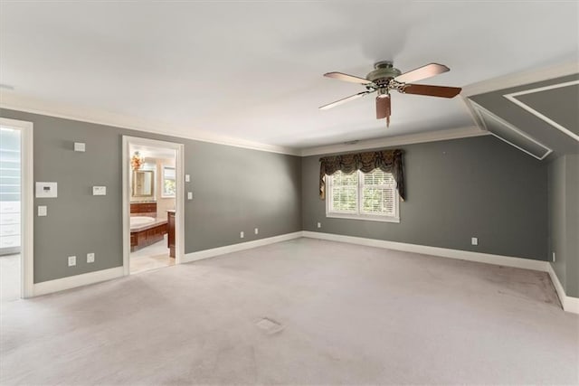 unfurnished bedroom featuring light carpet, crown molding, ensuite bath, and baseboards