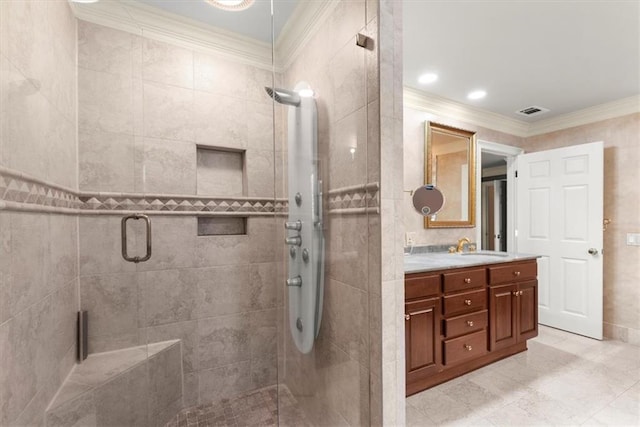 bathroom with crown molding, double vanity, visible vents, a stall shower, and a sink