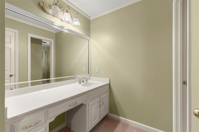 bathroom with ornamental molding, vanity, and baseboards