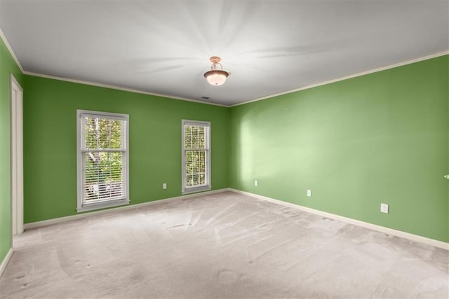 unfurnished room with crown molding, baseboards, and carpet flooring