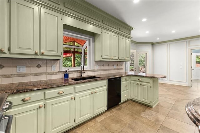 kitchen with green cabinetry, dishwasher, and a sink