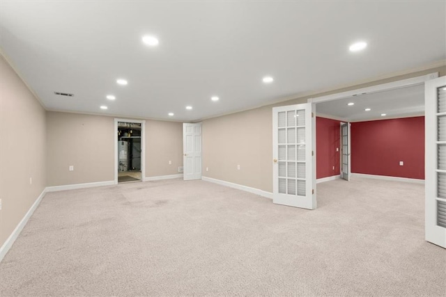 finished basement with baseboards, french doors, light carpet, and recessed lighting