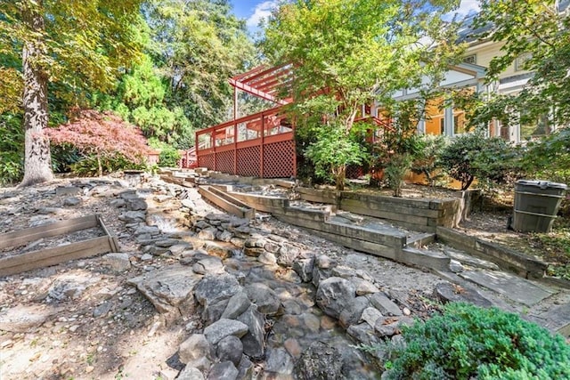 view of yard featuring a deck and a pergola