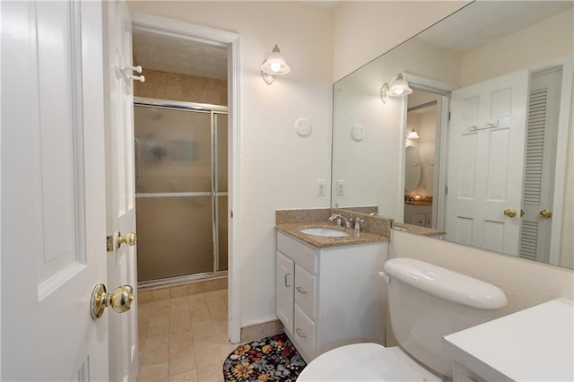 bathroom featuring walk in shower, toilet, tile patterned floors, and vanity