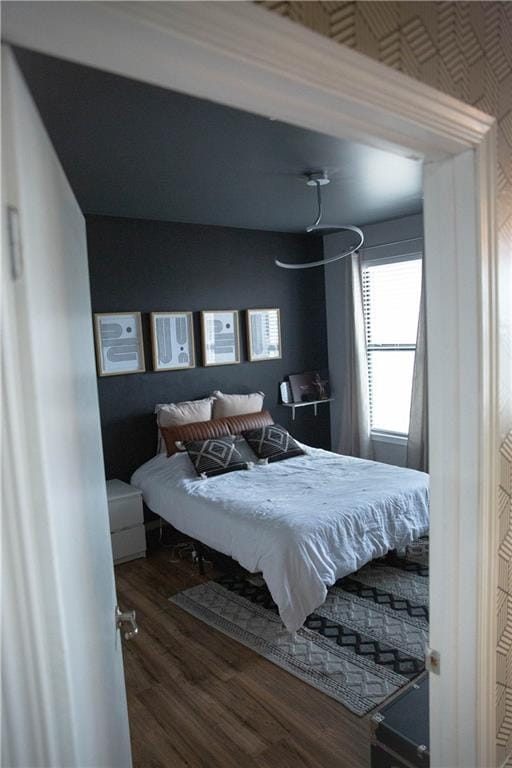 bedroom with dark wood-style flooring