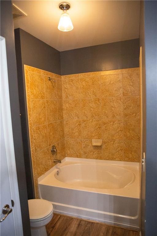 full bathroom with  shower combination, wood finished floors, and toilet