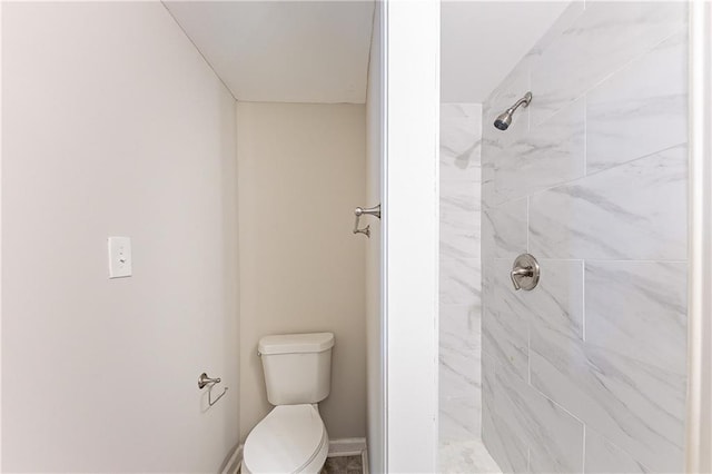 full bath with toilet and a tile shower
